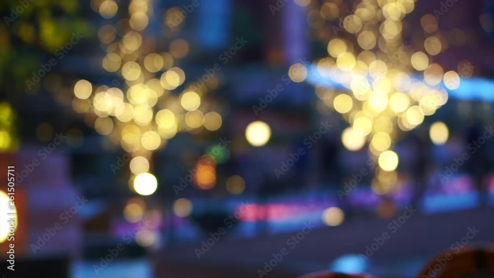Blur illumination Christmas tree lights people walking in city