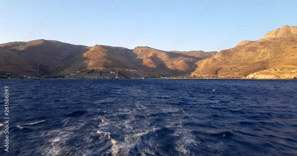 Sailing through beautiful Greek islands at sunset, back point of view of Catamaran