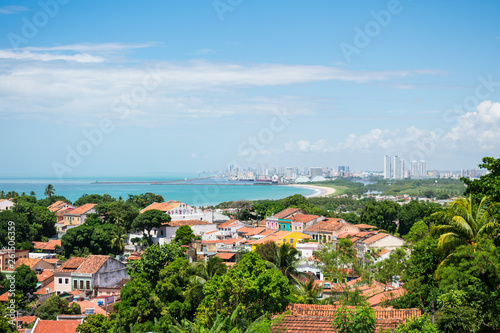 Fototapeta Naklejka Na Ścianę i Meble -  Olinda, Brazil - Circa April 2019: A view of Olinda's historic center from the top of Alto da Se hill, Recife in the background
