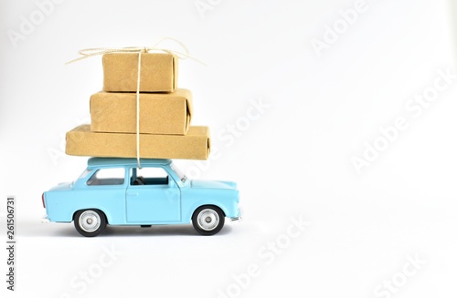 Delivery service, moving, shopping, sale concept, blue car carrying brown packages, copy space.