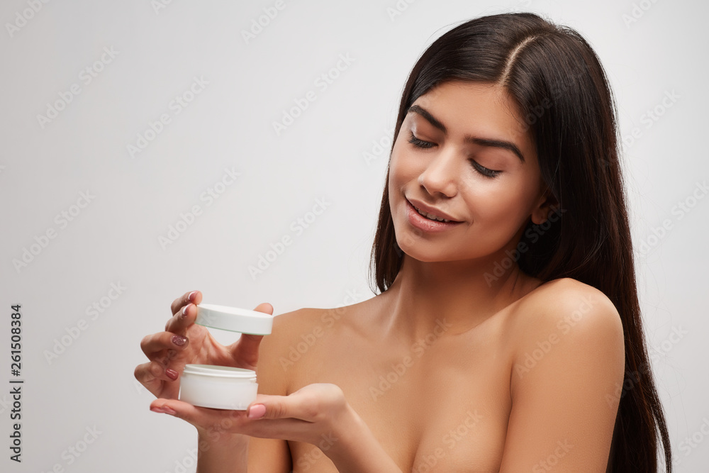 Beauty Face Care. Portrait Of Beautiful Happy Girl With Natural Makeup Holding cream jar In Hand. Beauty Face Care. Portrait Of Beautiful Happy Girl With Natural Makeup Holding cream jar In Hand.
