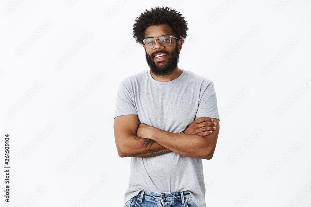 © Cookie Studio - Portrait of delighted calm and handsome african american male coworker in glasses with tattoos and pierced nose smiling joyfully and holding hands crossed on chest in confident pose as talking © Cookie Studio - Portrait of delighted calm and handsome african american male coworker in glasses with tattoos and pierced nose smiling joyfully and holding hands crossed on chest in confident pose as talking
