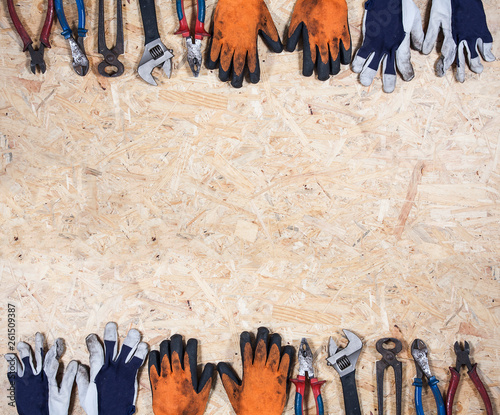 Old disrty tools on plywood background. Construction industry concept photo