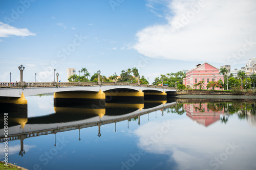Recife, Brazil - Circa April 2019: Bridge and a view of the historic neighborhood Santo Antonio reflecting on the waters of the Capibaribe river