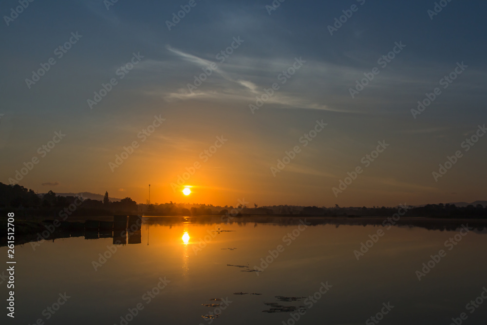 Landscape of reflexion sunrise with cloudy over lake in the morning of Thailand