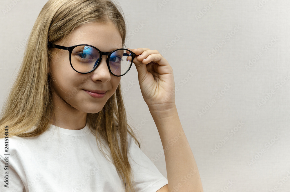 Portrait of a smiling beautiful young girl with glasses. Smart child. Nerdy Portrait of a smiling beautiful young girl with glasses. Smart child. Nerdy