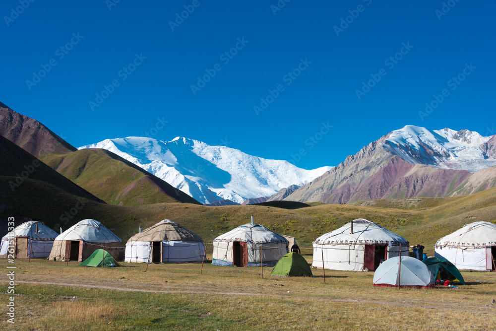 Osh, Kyrgyzstan - Aug 20 2018: Morning Landscape of Lenin Peak (7134m) at Tourist Yurt camp of Tulpar Kol Lake in Alay Valley, Osh, Kyrgyzstan. Pamir mountains in Kyrgyzstan.