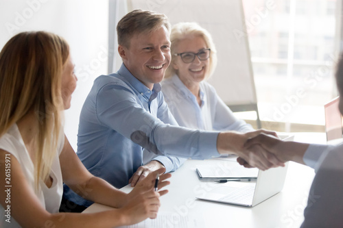 Happy caucasian employer hr handshake hire successful african candidate