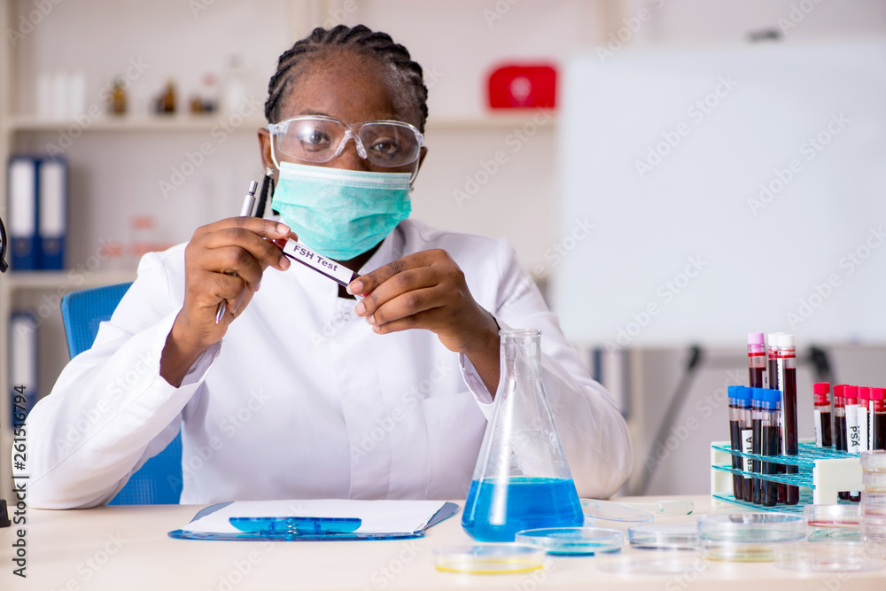 Young black chemist working in the lab Young black chemist working in the lab