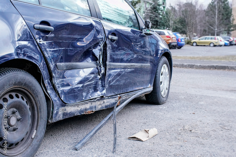 Crashed car after accident, detail on side - metal plates deformed