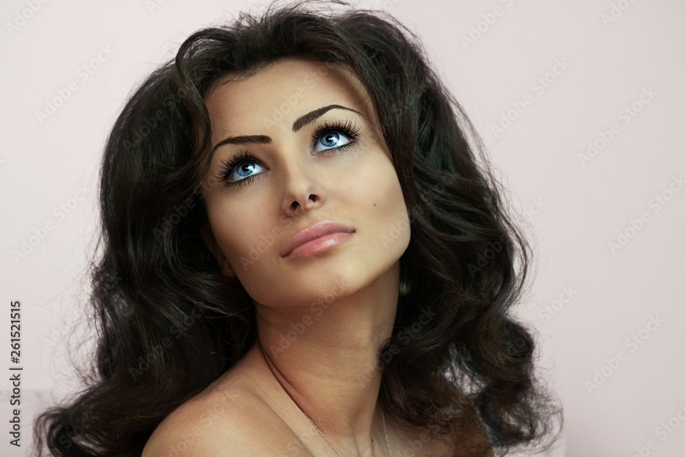 Fototapeta premium A close-up portrait of a young nude female model with curly black hair.-Image.