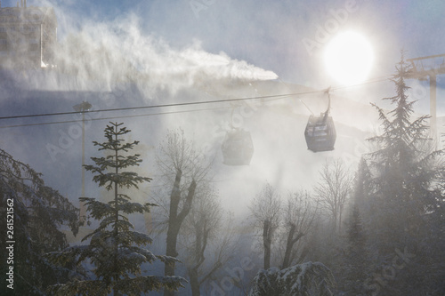 The cable car in the winter resort of Borreguiles in the Sierra Nevada is fogged by snow cannons