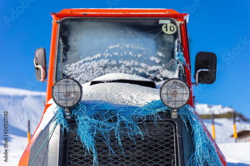 A red snow groomer in the snowy mountains of the Sierra Nevada in Andalusia