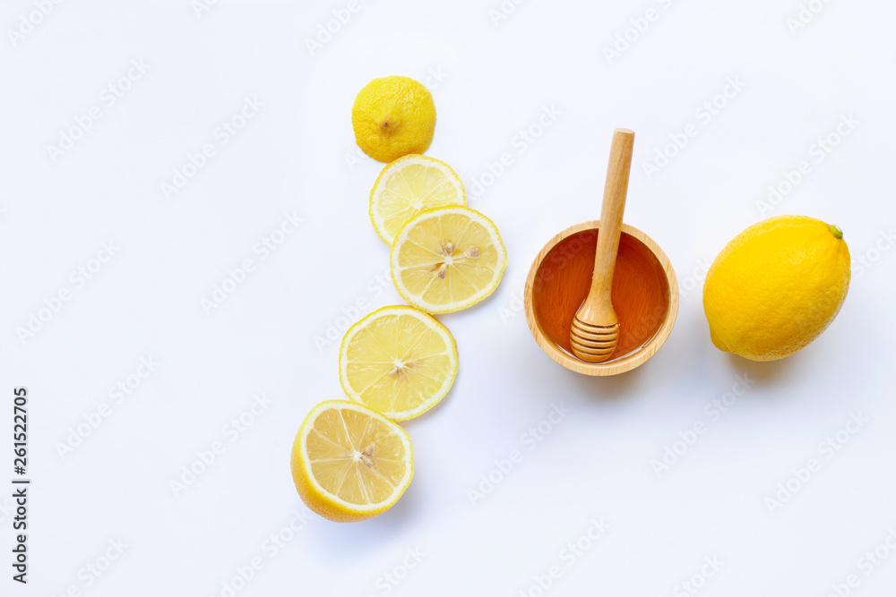 Honey with lemon on white background Honey with lemon on white background