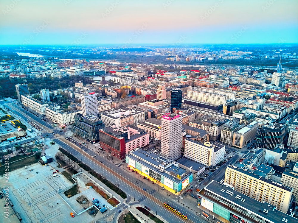 Fototapeta premium WARSAW, POLAND - APRIL 07, 2019: Beautiful panoramic aerial drone view to the center of Warsaw City in the sunset time in spring