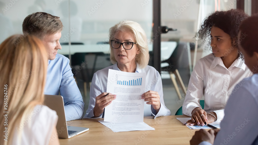 Older company executive presenting financial report result at team meeting Older company executive presenting financial report result at team meeting