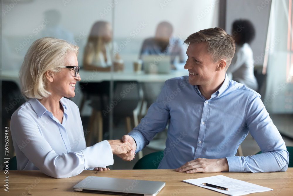 Happy male client employee handshake broker hr manager at meeting Happy male client employee handshake broker hr manager at meeting