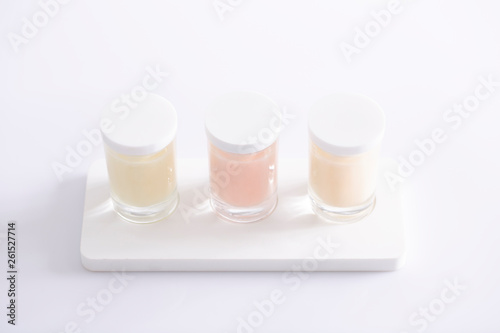 three glass cosmetic cointainers with skin care natural product photo