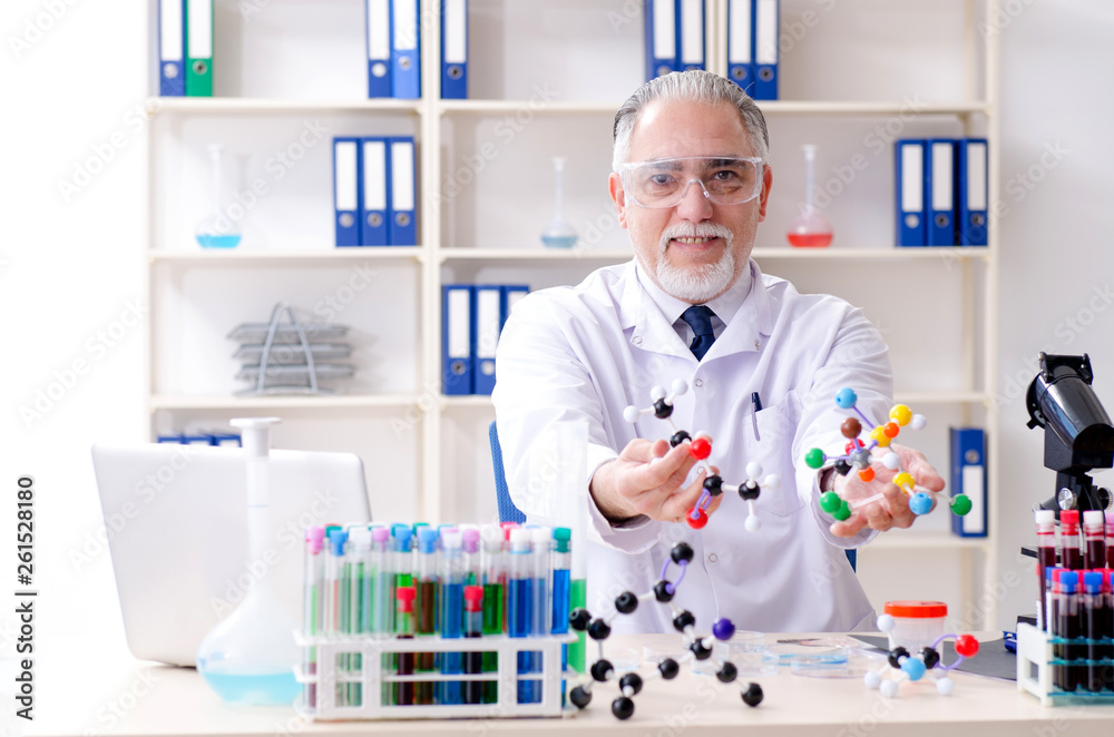 Old male chemist working in the lab Old male chemist working in the lab