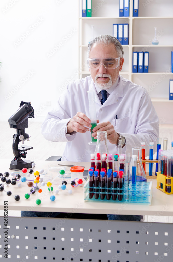 Old male chemist working in the lab Old male chemist working in the lab