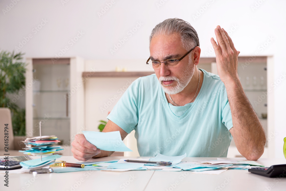 White bearded old man in budget planning concept White bearded old man in budget planning concept