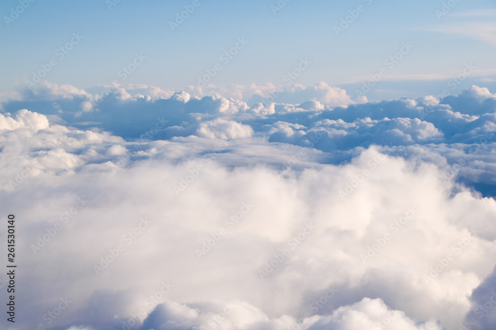 view from above the clouds from the airplane window