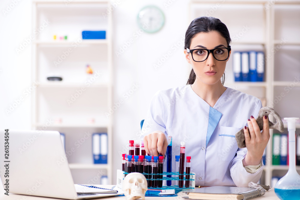 Young female archaeologist working in the lab 