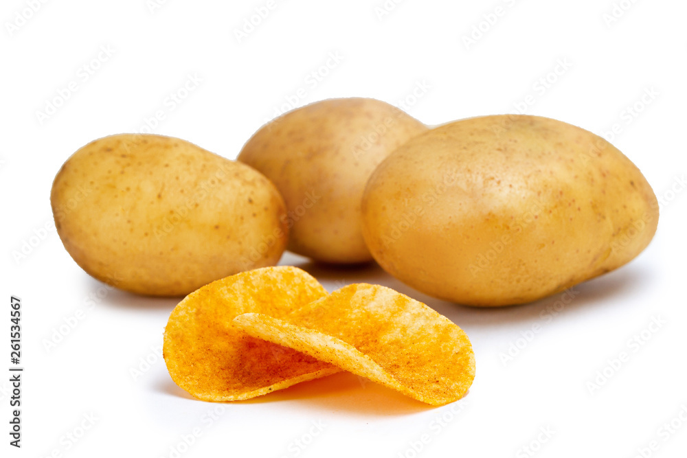 Isolated ripe potatoes and potato crunchy salted chips on white background