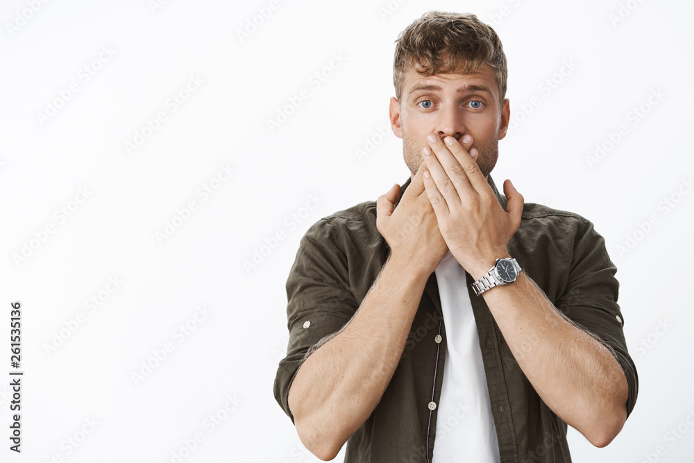 Waistup shot of shocked speechless handsome blond guy hearing