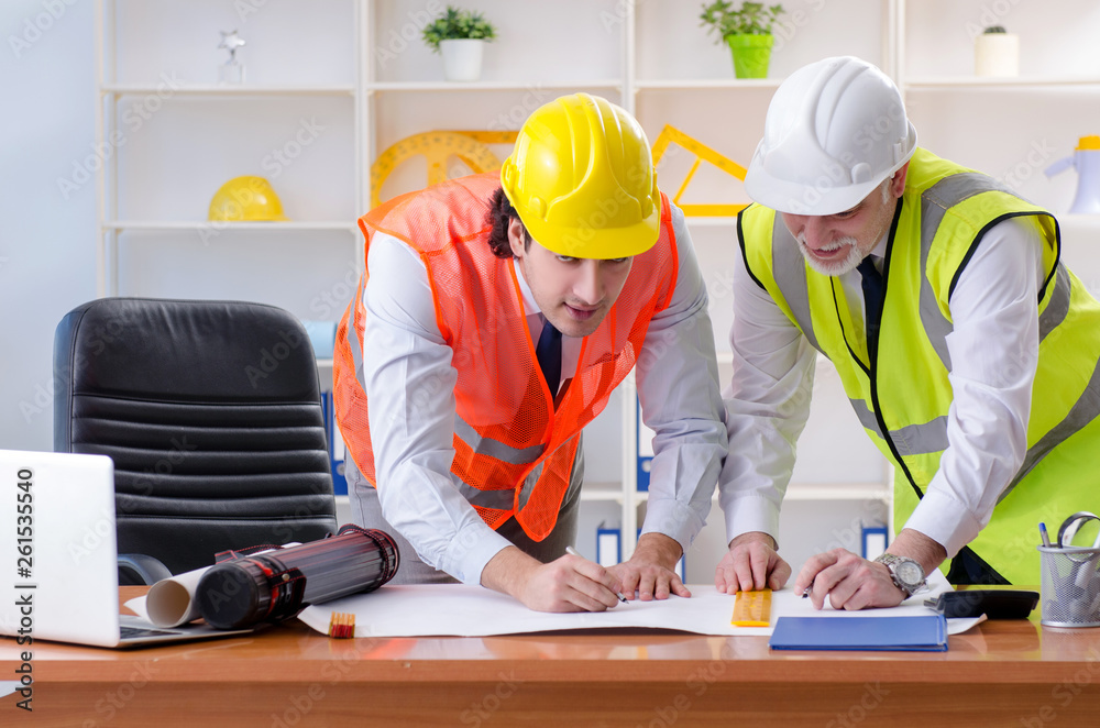 Two engineers colleagues working under project Two engineers colleagues working under project