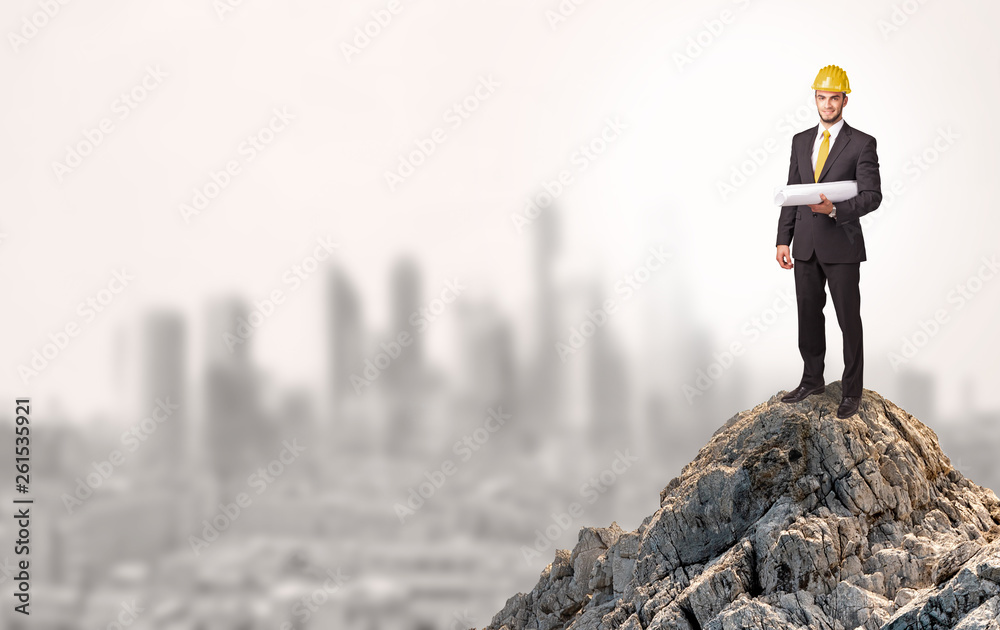 Young business person looking to the city from distance
Young business person looking to the city from distance