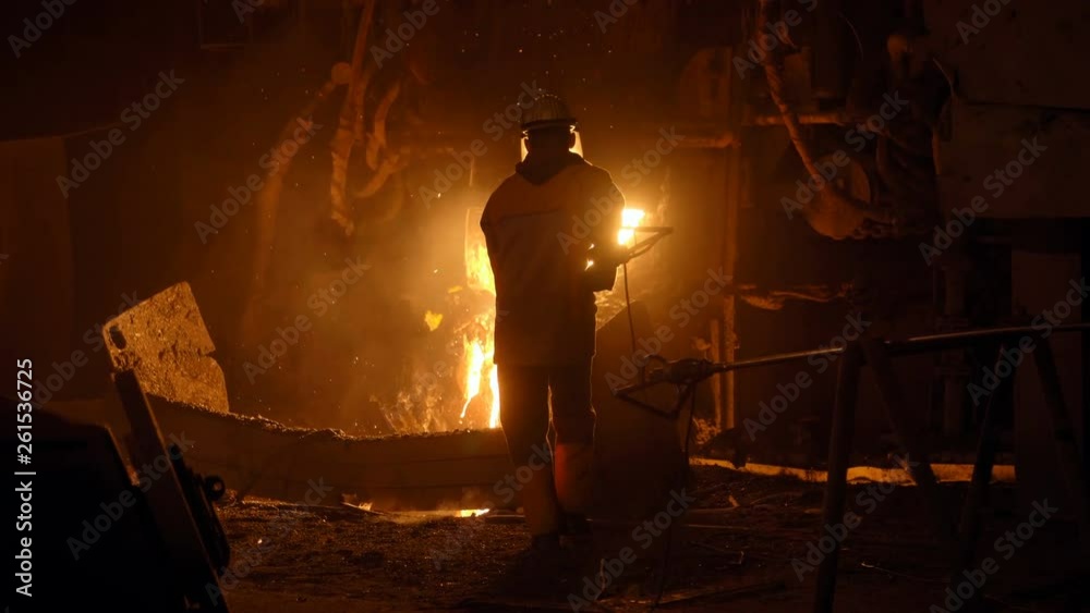Metallurgist at work by the blast furnance, iron and steel works Metallurgist at work by the blast furnance, iron and steel works