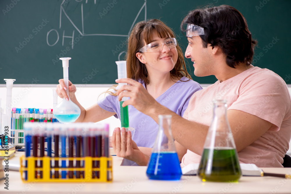 Two chemists students in classroom Two chemists students in classroom