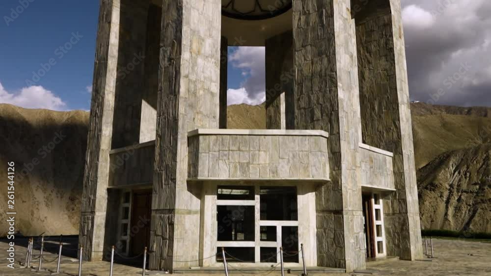 A hand held, tilting, medium shot of the entrance to the monument of Panjshir and the top of the monument. A hand held, tilting, medium shot of the entrance to the monument of Panjshir and the top of the monument.