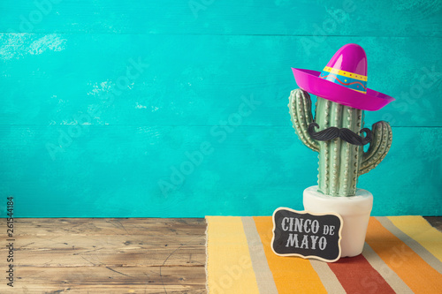 Cinco de Mayo holiday background with Mexican cactus and  party sombrero hat on wooden table