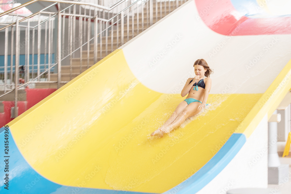 girl rides with a water slide in the water park Stock Photo | Adobe Stock