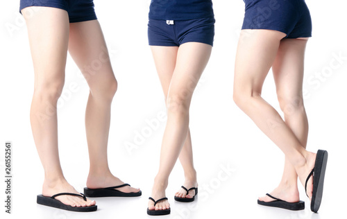 Set woman legs in black flip flops on white background isolation