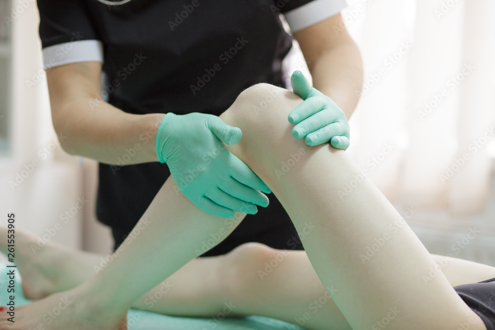 Master shugaring applies thick sugar paste on the legs of a young girl, removing hair on the legs. The process of sugar depilation. Master shugaring applies thick sugar paste on the legs of a young girl, removing hair on the legs. The process of sugar depilation.