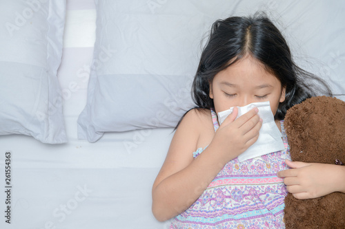 Asian girl blowing the nose by tissue