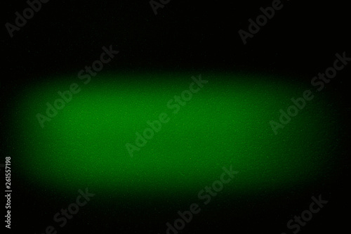 Blurred textural cloud of green color on a black background