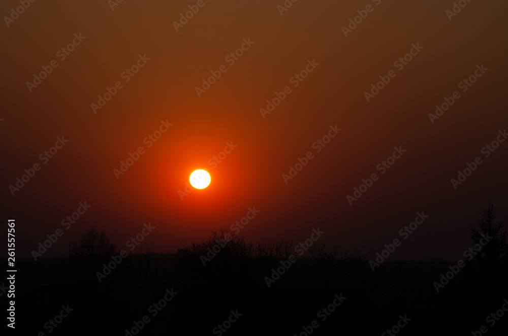 Incredible, beautiful, Bright sunset over the city. Gradient, the core of the sun. Beautiful sunset, red, orange