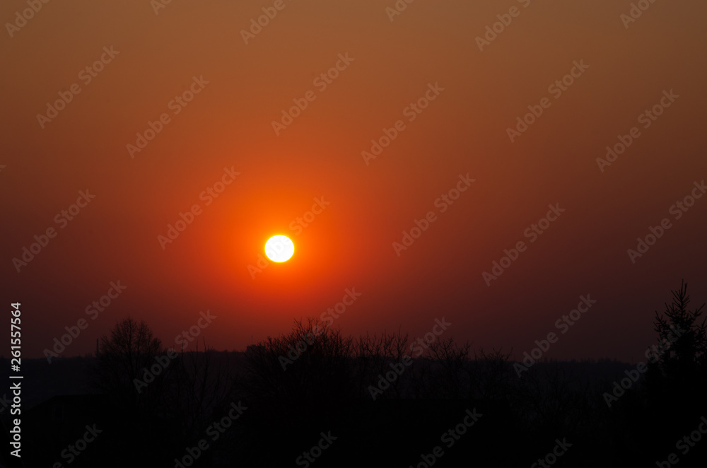 Incredible, beautiful, Bright sunset over the city. Gradient, the core of the sun. Beautiful sunset, red, orange