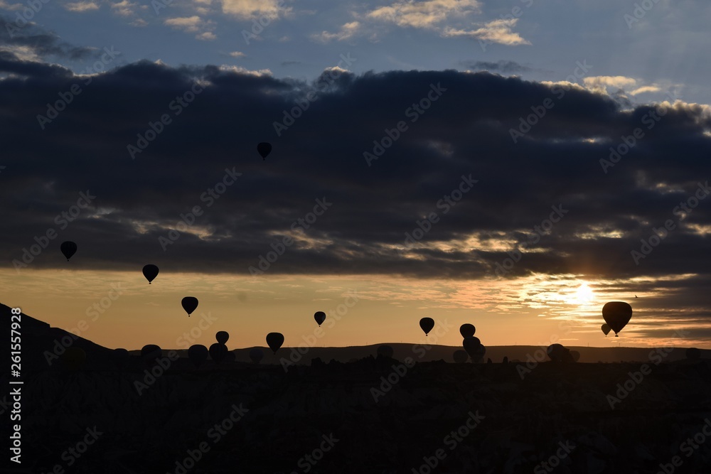 Sunrise and balloons. Beautiful background of the balloon and the sunset.Cappadocia. Turkey. Göreme. Nevşehir. Türkiye. 8. 04. 2019. Balloons flying over the rocky landscape in Cappadocia Turkey. 