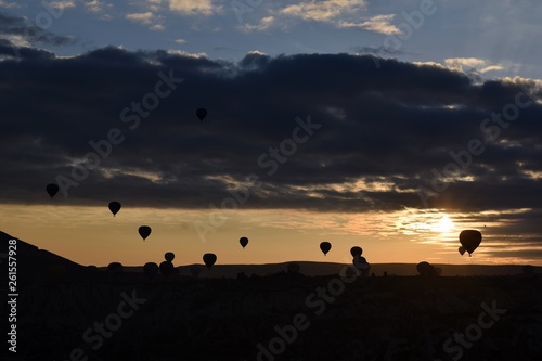 Sunrise and balloons. Beautiful background of the balloon and the sunset.Cappadocia. Turkey. G  reme. Nev  ehir. T  rkiye. 8. 04. 2019. Balloons flying over the rocky landscape in Cappadocia Turkey. 