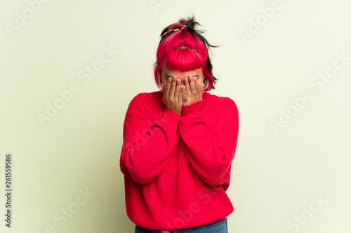 Young woman with red sweater with tired and sick expression