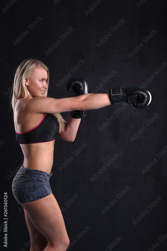 Young strong girl in boxing gloves Young strong girl in boxing gloves