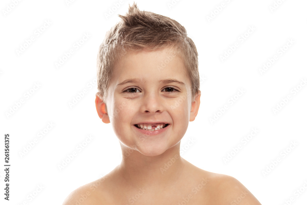 Cute laughing boy without a front tooth. Isolated on a white background. Close-up. Cute laughing boy without a front tooth. Isolated on a white background. Close-up.