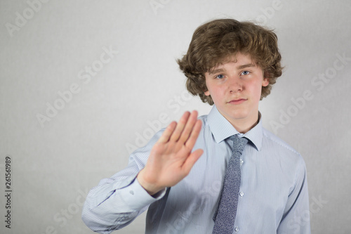 Young handsome man over isolated background doing stop sing with palm of the hand. Warning expression with negative and serious gesture on the face.