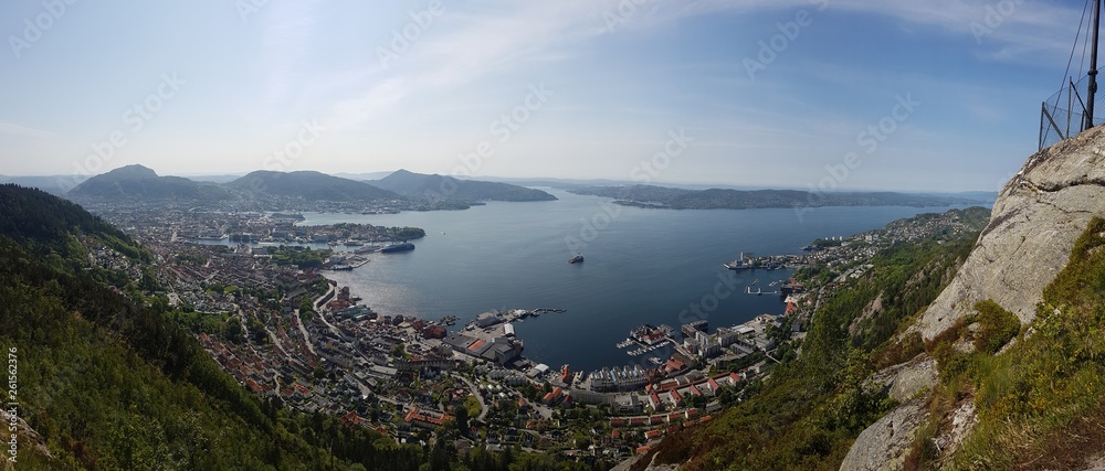 A beautiful and breathtaking view on Bergen, Norway, seen from the hill above the city. Endless fjords joining the sea. Sunny weather with a little bit of the mist over the horizon.