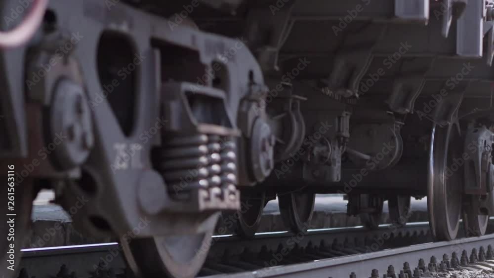 The wheels of old train on the railway track passing by camera. Close up shot
